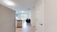 Located at 120–152 N Frontage Rd in Mansfield Center, CT, this efficiently designed one-bedroom, one-bathroom residence offers a thoughtful layout across a single floor. The open-concept kitchen and living area creates a seamless flow, with light wood-tone flooring extending throughout the main living spaces. The kitchen is a standout feature, equipped with full stainless steel appliances including a refrigerator, electric range, and microwave, complemented by crisp white shaker cabinetry, granite-look countertops, and a peninsula with bar seating — ideal for casual dining. The living room is bright and inviting, benefiting from a large window that frames views of surrounding greenery, allowing natural light to fill the space. The bedroom offers a comfortable and private retreat, carpeted for warmth, with a sizable window overlooking lush trees and ample room for storage. The bathroom features a clean walk-in shower with a full-height surround. Throughout the residence, neutral wall tones and modern finishes contribute to a fresh, contemporary aesthetic that is both functional and welcoming.