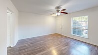 Located at 100 Pleasant Ct in Newport News, VA, this two-story home offers a thoughtfully designed layout spread across two floors. The main level features a bright, open living room with durable laminate hardwood flooring, a ceiling fan with light fixture, and easy access to additional rooms. The kitchen is well-equipped with white cabinetry, granite-style countertops, a gas range, dishwasher, refrigerator, and microwave. A standout feature is the in-unit stacked washer and dryer conveniently integrated into the kitchen space. Natural light flows in through a large window, enhancing the kitchen's airy feel. A clean, simply appointed half bathroom with a pedestal sink completes the main floor. Upstairs, two bedrooms offer comfortable retreats, each featuring ceiling fans and hardwood flooring. The primary bedroom provides a generous footprint with ample natural light. The second bedroom includes a bi-fold closet and a window with outdoor views. A full bathroom on the upper level features a tiled tub-shower combination. Throughout the home, clean white walls, consistent flooring, and ceiling fans in every room contribute to a cohesive, comfortable living environment.