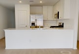 This contemporary single-story residence at 14210 Timber Fields Way in New Caney, TX offers 1,160 square feet of thoughtfully designed living space. The home features three bedrooms, including a spacious 170 square foot primary suite, and two full bathrooms. The modern kitchen is equipped with sleek white cabinetry, stainless steel appliances, and a gas range, creating an inviting space for culinary enthusiasts.

The interior boasts a bright and airy atmosphere, enhanced by large windows that allow natural light to flood the rooms. The living areas showcase light-colored flooring, contributing to the home's open and spacious feel. Ceiling fans in the bedrooms provide comfort and air circulation.

Both bathrooms are designed with contemporary fixtures and finishes, including built-in shelving in the shower areas for added convenience. The home's neutral color palette offers a blank canvas for personalization.

Exterior features include a single-car attached garage, a concrete driveway, and a fenced backyard, perfect for outdoor relaxation or entertainment. The property's facade combines brick and siding elements, creating an appealing curb presence in this residential neighborhood.

With its modern amenities and efficient layout, this home presents an ideal option for those seeking a contemporary living space in New Caney, Texas.