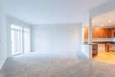 Located at 100 Cary St in Hampton, Virginia, this single-story residence offers a thoughtfully designed layout with a comfortable, functional flow throughout. The open-concept living area is finished with neutral-toned wall-to-wall carpeting, creating a warm and inviting atmosphere. Large sliding glass doors and generously sized windows allow abundant natural light to fill the space while providing outdoor views, enhancing the overall sense of openness.

The kitchen is a standout feature, showcasing rich, dark-stained wood cabinetry with sleek bar-pull hardware, bold dark granite countertops, and light hardwood-style flooring. Stainless steel appliances, including a range, microwave, and refrigerator, complete the space. A peninsula counter connects the kitchen to the living area, making it ideal for everyday use.

The bedrooms are carpeted and generously proportioned, each featuring walk-in or reach-in closets with built-in shelving and rod systems for organized storage. Windows in the bedrooms bring in natural light and exterior views.

The bathrooms are finished with neutral tile flooring and include full soaking tub and shower combinations with curved curtain rods, chrome fixtures, and wood-toned vanities with light countertops, maintaining a clean and consistent aesthetic throughout the unit.