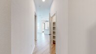 Located in Riverview, FL, this well-appointed 2-bedroom, 2-bathroom single-story home offers a clean, modern aesthetic throughout. Light wood-tone flooring flows seamlessly across the open-concept living and dining areas, complemented by crisp white walls that enhance the bright, airy ambiance.

The kitchen is a functional highlight, showcasing white shaker-style cabinetry extending to the ceiling, granite countertops, a white subway tile backsplash, and a full suite of stainless steel appliances. Natural light filters in through multiple windows, and a door provides convenient outdoor access directly from the kitchen.

Both bedrooms are comfortably proportioned with large windows that invite natural light and offer views of the surrounding community. The primary bedroom features its own walk-in closet equipped with wire shelving systems, while a second walk-in closet provides additional storage. A third closet with built-in shelving is accessible from the hallway.

Each bathroom is finished with granite-topped white vanities, brushed nickel hardware, tile flooring, and a tiled walk-in shower, delivering a cohesive and polished look. The hallways are well-lit and include a built-in shelving nook for added functionality. Throughout the home, the consistent use of neutral tones and quality finishes creates a clean, move-in-ready environment.