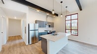 Step into a world of contemporary elegance and boundless potential. This exquisite 850 square foot haven, nestled in the vibrant heart of Olympia, is more than just a home—it's a canvas for your dreams. The moment you enter, you'll be captivated by the seamless blend of form and function. Gleaming hardwood floors extend throughout, creating a warm, inviting atmosphere that beckons you to relax and unwind.

The kitchen is a culinary enthusiast's dream, boasting sleek gray cabinetry, state-of-the-art stainless steel appliances, and a stunning white quartz island. Illuminated by chic pendant lights and bathed in natural light from the expansive windows, this space is perfect for both everyday meals and entertaining guests.

Two generously sized bedrooms, including a 130 square foot primary suite, offer tranquil retreats for rest and rejuvenation. The bathrooms are masterpieces of modern design, featuring contemporary vanities, pristine fixtures, and ample space for pampering.

Large windows frame picturesque views of the surrounding cityscape, while flooding the living areas with an abundance of natural light. The open-concept layout creates a sense of spaciousness and flow, ideal for both relaxation and socializing.

This home is not just a place to live—it's a lifestyle upgrade. Embrace the vibrant energy of downtown Olympia, indulge in the local culture, and return each day to your personal sanctuary. Don't just imagine the possibilities—make them your reality in this extraordinary urban retreat.