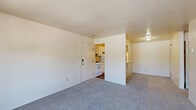 Located at 2102 Point West Dr in Fort Wayne, Indiana, this one-bedroom, one-bathroom unit offers a practical and well-organized single-floor layout. The living room is carpeted and filled with natural light from a sliding glass door that opens onto a private balcony, offering pleasant outdoor views of the surrounding community. A wall-mounted air conditioning unit provides dedicated climate control in this space.

The galley-style kitchen features wood-look flooring, white cabinetry with updated hardware, light granite-style countertops, a gas range, and a full-size refrigerator. A pass-through counter connects the kitchen to the living area, creating an open feel and convenient serving space. The kitchen also provides access to additional storage.

The bedroom is a comfortable size, finished with carpet and a window fitted with blinds that allows for natural light. A set of bifold doors opens to a built-in closet with a hanging rod and shelving, providing ample storage.

The bathroom features wood-look flooring, a single-sink vanity with white cabinetry and a light countertop, a wall-mounted mirror, and a full tub-shower combination. The clean, neutral finishes throughout the unit create a cohesive and functional living environment.