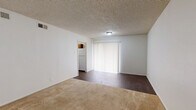 This one-bedroom, one-bathroom unit at 4110 Arthur Lane in Beaumont, TX offers a practical and comfortable single-floor layout. The open living area is expansive, finished with warm beige carpeting and neutral cream-toned walls that create a bright, inviting atmosphere. A textured ceiling and large vertical-blind-covered window allow natural light to fill the space, while HVAC vents ensure year-round climate control. A secondary living area near the entry features hard flooring and provides flexible use as a dining or sitting space.

The kitchen is functional and well-appointed, featuring warm wood cabinetry, a double stainless steel sink with updated faucet, light gray countertops, and a dishwasher. Tile flooring adds a clean, practical finish to this workspace.

The generously proportioned bedroom includes a ceiling fan with light fixture, a window with blinds for natural light and privacy, and notably, two open closets side by side, offering ample storage. The textured ceiling is consistent throughout the unit.

The bathroom is clean and straightforward, featuring a full-size tub and shower combination with chrome fixtures. A hallway connects the main living spaces efficiently, and three closets throughout the unit provide excellent overall storage for a residence of this size.