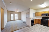 Located at 11900 Oakmoor Pkwy in Houston, TX, this 2-bedroom, 3-bathroom single-floor residence offers a functional and well-organized layout. The open-concept kitchen and living area serves as the heart of the home, where wood-look flooring flows into a carpeted living space. The kitchen is equipped with warm honey-toned cabinetry, white countertops, black appliances including a range, built-in microwave, refrigerator, and dishwasher, plus a double sink and a pass-through peninsula that connects to the living area. A ceiling fan anchors the living room, which receives natural light through a double-panel front window and a glass door leading outside. The primary bedroom is a comfortable retreat featuring plush carpet, a ceiling fan, and direct outdoor access through a windowed door. It is serviced by a dedicated closet and nearby bathroom access. The second bedroom also offers carpet flooring, a ceiling fan, a natural-light window, and its own closet with built-in wire shelving. A dedicated walk-in closet with multi-tiered wire shelving and a washer/dryer hookup provides practical storage and laundry convenience. The bathrooms feature tiled tub-shower combinations with accent tile detailing and wood-look flooring. Hallways connect the rooms efficiently, completing this neatly arranged Houston residence.
