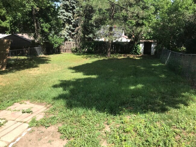 fenced in backyard with a patio, shade, and a storage shed - 816 S Glendale Ave