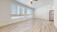 Located at 1930 T St in Sacramento's 95811 neighborhood, this two-story, 2-bedroom, 3-bathroom home offers a clean, modern aesthetic across two well-proportioned floors. The main level features a bright living room with light hardwood-style flooring, a ceiling fan, and direct access to a staircase connecting both levels. The kitchen is well-appointed with white shaker cabinetry extending to the ceiling, stainless steel appliances including a refrigerator, range, microwave, and dishwasher, light wood-tone flooring, and a window that brings in natural light. Three bathrooms are distributed throughout the home, including one with a soaking tub and shower combination, and another with a clean, minimal layout and wood-style flooring. Upstairs, the two bedrooms are finished with plush carpet and feature windows fitted with horizontal blinds, allowing for natural light and privacy. The primary bedroom includes a closet with a sliding door and built-in rod. The secondary bedroom mirrors the same comfortable, neutral design. A hallway connects the upper-level rooms, and the overall color palette of whites and warm neutrals lends a fresh, move-in-ready feel throughout.