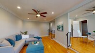 Located at 365 Stewart Ave in Garden City, New York, this residence offers a refined single-floor layout characterized by consistent design details and quality finishes throughout. Warm honey-toned hardwood floors flow seamlessly across the living areas, complemented by crisp crown molding and neutral gray walls that create a bright, cohesive atmosphere.

The spacious living area serves as the heart of the home, featuring recessed lighting, a ceiling fan, and a split-level layout with stylish black iron railings that add architectural interest. Built-in shelving with arched accents provides both character and functional display space. Large windows allow natural light to fill the room, enhancing the open feel.

The galley-style kitchen is well-equipped with rich dark wood cabinetry, light quartz countertops, a subway tile backsplash, and a window overlooking the outdoors. Tile flooring and ample storage make this a practical and attractive cooking space.

The bedroom is a comfortable retreat, complete with a ceiling fan, crown molding, hardwood floors, and recessed lighting. An additional room with hardwood floors and crown molding offers flexible use as a second bedroom or office. The bathroom features classic white tile, a soaking tub with shower, and mosaic tile flooring. A conveniently located laundry area adds everyday practicality to this well-rounded home.