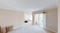 Located at 1190 Encinitas Boulevard, unit #269 is a single-level residence characterized by a clean, neutral palette and consistent design elements throughout. The entryway features tile flooring and crown molding, establishing a polished tone that carries into the main living areas.

The living and dining areas are carpeted and finished with crown molding, warm beige walls, and vertical blinds. A ceiling fan adds functionality, while sliding glass doors open to a private patio that brings in natural light and offers views of surrounding greenery, creating a bright and open atmosphere.

The kitchen is equipped with warm oak cabinetry — both upper and lower — along with light countertops, a double sink, recessed lighting, and tile flooring. Appliances include a refrigerator and dishwasher, providing practical utility in a compact layout.

The bedrooms are carpeted and well-lit by natural light through large windows with vertical blinds. The primary bedroom includes an expansive wall of sliding-door closets, offering generous storage. A secondary bedroom provides additional flexible living space.

The bathroom features a wide vanity with oak cabinetry, a large mirror with overhead lighting, and a tub/shower combination, delivering a functional and tidy finish consistent with the rest of the unit.