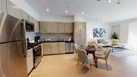 Located on Otsego Street in North Hollywood, Los Angeles, this single-floor residence showcases a contemporary design aesthetic defined by clean lines, light wood flooring, and a bright, neutral color palette throughout.

The open-concept kitchen is a functional centerpiece, featuring light wood cabinetry extending to the ceiling, dark countertops, a tile backsplash, and a full suite of stainless steel appliances including a gas range, built-in microwave, dishwasher, and refrigerator. The kitchen flows seamlessly into the dining area, creating an inviting space well-suited for everyday living and entertaining.

The living area is bathed in natural light from large sliding glass doors fitted with roller shades, and includes built-in shelving that adds both practicality and visual interest. The spacious primary bedroom features light wood flooring, generous proportions, and direct access to a bathroom. A secondary bedroom offers a distinct character with an accent wall in muted green tones, a private entrance door, and ample space for both sleeping and a dedicated work area.

The bathrooms are finished with light wood vanities, dark countertops, large mirrors, and tiled shower-tub combinations, maintaining the residence's cohesive modern aesthetic throughout.