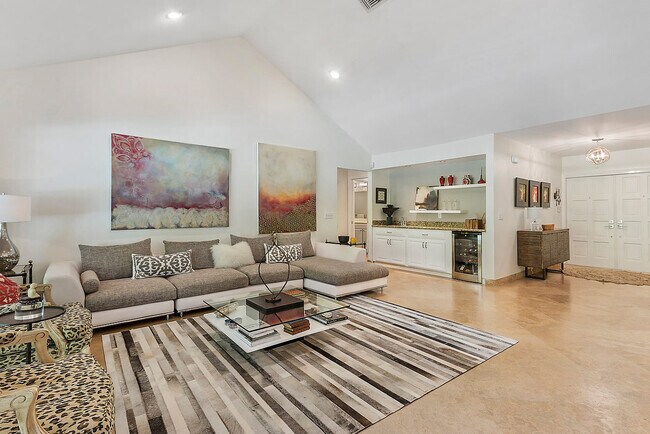 Living room features bar area with refrigerator and sink for entertaining - 2535 NW 41st St House