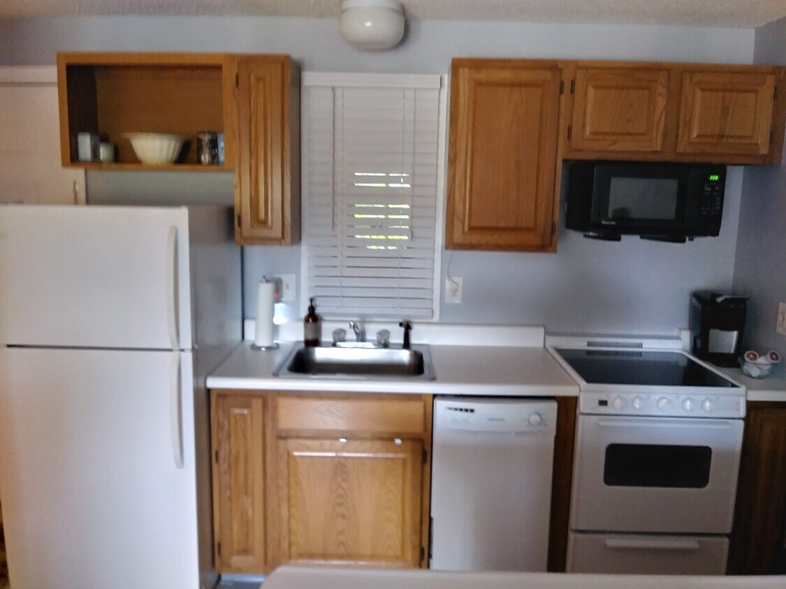 Full kitchen with counter and bar seating - 118 Weirs Rd