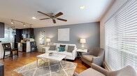 Located at 3405 N Shepherd Dr in Houston, TX, this single-story, 2-bedroom, 2-bathroom home offers a thoughtfully designed layout across a comfortable footprint. The inviting living room features rich hardwood flooring, a ceiling fan, recessed lighting, and a bold slate-blue accent wall that adds depth and character to the space. Large windows dressed with blinds allow generous natural light throughout.

The galley-style kitchen is a standout, showcasing dark espresso cabinetry, granite-style countertops, stainless steel appliances, and track lighting overhead. It opens directly to a dedicated dining area framed by dual windows. Both bedrooms are carpeted and include ceiling fans, ample closet space, and natural light. The primary bedroom offers a spacious, comfortable retreat.

A flexible office space with carpet flooring and a ceiling fan provides an ideal work-from-home area. The bathrooms feature dark vanity cabinetry with granite-style counters, hardwood flooring, and tub-shower combinations. A connecting hallway ties all rooms together efficiently. The home's neutral palette, consistent finishes, and practical room variety make it a highly functional and attractive Houston residence.