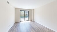 Located in the heart of Fort Lauderdale, this modern 3-bedroom, 1-bathroom residence offers a thoughtfully designed single-floor layout with clean, contemporary finishes throughout. The open-concept kitchen and living area serves as the heart of the home, featuring sleek white flat-panel cabinetry, a marble-look tile backsplash, stainless steel appliances including a French door refrigerator, electric range, and built-in microwave, plus a central island with a warm wood base and quartz countertop illuminated by stylish pendant lighting. Wood-look flooring flows seamlessly through the living areas and bedrooms, adding warmth to the neutral color palette. The living room opens directly to a private balcony through sliding glass doors, offering views of the lively urban surroundings and greenery below. Each bedroom is bright and well-proportioned, with large windows or balcony access inviting natural light. The bathroom is finished with marble-look tile flooring, a backlit vanity mirror, and a glass-enclosed shower, with direct access to a dedicated walk-in closet featuring built-in wire shelving. A hallway connects the bedrooms and provides a functional flow throughout the unit, completing this well-appointed Fort Lauderdale residence.