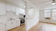 Located at 861 Fedora St in the Koreatown neighborhood of Los Angeles, this single-floor unit showcases a clean, modern aesthetic with fresh finishes throughout. Warm-toned hardwood flooring runs continuously across every room, creating a cohesive and inviting atmosphere. Crown molding adds a refined architectural detail to the living and bedroom spaces.

The kitchen is a standout feature, outfitted with crisp white shaker cabinetry, white quartz countertops, a stainless steel undermount sink, and a stainless steel gas range with oven. A pass-through opening connects the kitchen to the main living area, enhancing the sense of openness and flow between spaces. A refrigerator is also included.

The living area is spacious and well-lit, with a ceiling fan providing comfort and airflow. It opens naturally toward the bedroom, which benefits from large multi-pane windows that invite abundant natural light and offer views of the surrounding neighborhood streetscape, including mature trees.

The bathroom is finished in a bright, neutral palette with a white vanity, medicine cabinet mirror, toilet, and a window that provides natural ventilation. The overall design of the unit emphasizes clean lines, light-filled interiors, and functional simplicity, making it a well-appointed space in a prime Los Angeles location.