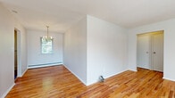 Located at 27-55 Green St in Westwood, NJ, this 1-bedroom, 1-bathroom residence offers a well-organized single-floor layout that makes efficient use of its space. Warm hardwood floors run throughout the living areas, dining room, and bedroom, lending a consistent and inviting character to the entire home.

The living room is bright and open, with natural light filtering in through windows that frame views of the surrounding greenery. It flows naturally into the dedicated dining area, which is appointed with a classic gold chandelier, adding a touch of elegance to everyday meals.

The kitchen is thoughtfully equipped with warm wood cabinetry, granite-style countertops, a tile backsplash, and full appliances including a gas range, dishwasher, and sink — all complemented by a window overlooking the outdoors.

The bedroom is a comfortable, well-proportioned room featuring hardwood flooring, natural light from a window, a closet, and baseboard heating for year-round comfort.

The bathroom is clean and functional, finished in white tile with a full soaking tub and shower combination, a vanity with storage, and a grab bar for added convenience.

Throughout the home, neutral wall tones and hardwood floors create a cohesive, light-filled ambiance ideal for easy living in a desirable Westwood location.