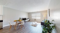 Located at 140 Anton St in Bridgeport, Connecticut, this well-appointed single-floor unit offers a thoughtfully designed layout that balances comfort and functionality. The open-concept living and dining area is anchored by durable wood-look flooring, neutral gray walls, and a bright window fitted with blinds that allow natural light to fill the space. A wall-mounted air conditioning unit ensures year-round comfort.

The kitchen is a standout feature, showcasing white shaker-style cabinetry, granite-look countertops, a classic subway tile backsplash, and a full suite of stainless steel appliances including a refrigerator, range, and microwave. The kitchen flows naturally into the dining and living areas, making the space ideal for everyday living and entertaining.

The bedroom is generously sized, finished with plush carpeting and soft gray walls. It benefits from natural light through a large double window and offers exceptional storage with two double-door closets flanking the room. The bathroom is clean and functional, featuring mosaic tile flooring, white subway tile wainscoting, a vanity with under-sink storage, and a well-lit mirror above the sink. This unit combines modern updates with a practical, comfortable layout.