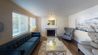 Located at 35810 16th Ave S in Federal Way, WA, this ground-floor unit offers a well-organized, single-level layout designed for comfortable everyday living. The living room serves as the heart of the space, featuring a tiled fireplace with a classic white mantle, wood-style flooring, and multiple windows fitted with horizontal blinds that allow ample natural light to filter in. Adjacent to the living area, a dedicated dining nook provides an intimate setting, conveniently open to the kitchen via a pass-through counter. The galley-style kitchen is efficiently designed with white cabinetry, laminate countertops, a stainless steel refrigerator, electric range, dishwasher, and a double basin sink — offering generous storage and functionality. The bedroom is a comfortable retreat with a window for natural light and direct access to a well-appointed full bathroom featuring dual sinks, a large vanity mirror, and a combined tub-shower. A second bathroom includes a tub-shower combo with a curtain enclosure. The entryway features a full-size closet with bi-fold doors and wood-look flooring that carries consistently through the common areas, completing this practical and neatly finished home.