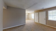 Located at 3111 S Leonard Springs Rd in Bloomington, Indiana, this single-story, 3-bedroom, 1-bathroom home offers a practical and comfortable layout. The living room is generously sized, featuring neutral gray walls, plush carpeting, and a textured ceiling. Natural light filters in through multiple windows, creating a bright and open feel. The space flows into a dedicated dining area adorned with a classic chandelier, adding a touch of warmth to the room.

The kitchen is efficiently designed with white cabinetry featuring gold-tone hardware, a gas range, refrigerator, dishwasher, and ample counter space. Tile flooring completes the functional cooking area.

Three well-proportioned bedrooms each feature soft carpeting, neutral-toned walls, and louvered bifold closet doors. The spacious primary bedroom offers generous square footage, a large window for natural light, and notable closet space. In total, the home includes six closets, providing exceptional storage throughout. A central hallway connects the main living areas to the bedrooms.

The bathroom is equipped with a full tub-shower combination in a clean, white surround with tile flooring. The single-floor layout ensures easy accessibility, and the overall design offers a straightforward, livable floor plan well-suited for everyday life.