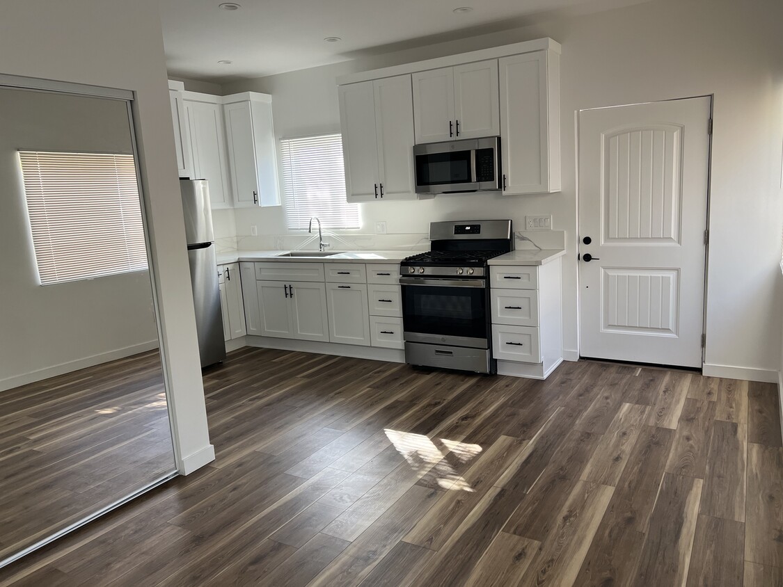 Kitchen and entry door seen from the living area. - 1026 Simmons Ave