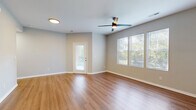 Located at 5555 W 6th St in Lawrence, Kansas, this well-appointed 1-bedroom, 1-bathroom unit offers a thoughtfully designed single-floor layout with a clean, modern aesthetic throughout. The spacious living room greets you with warm hardwood-style flooring, neutral gray walls, a ceiling fan, and multiple windows that invite abundant natural light and views of surrounding greenery. A private entry door adds a welcoming touch to the open, airy feel of the space. The kitchen is a standout feature, showcasing white shaker cabinetry with matte black hardware, sleek quartz-style countertops, a stainless steel sink, and a full suite of stainless steel appliances including a refrigerator, range, microwave, and dishwasher. A breakfast bar provides additional counter space and casual dining options. The bedroom is comfortably sized with plush carpeting, a ceiling fan, and a window overlooking the outdoors. It connects to a generously sized walk-in closet outfitted with wire shelving for efficient organization. Two additional closets provide ample storage throughout the unit. The full bathroom features wood-look flooring, a white vanity with marble-style countertop, matte black fixtures, and a shower-tub combination. A dedicated laundry room with a full-size washer and dryer completes this practical and polished home.