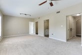This single-floor residence in Atlanta's 30327 zip code offers a well-designed layout with a clean, neutral aesthetic throughout. The kitchen is outfitted with white shaker-style cabinetry, granite countertops, subway tile backsplash, wood-look flooring, and a full suite of stainless steel appliances including a refrigerator, range, and over-the-range microwave. Convenient in-unit laundry is tucked into a dedicated closet space complete with wire shelving, accommodating a full-size washer and dryer side by side. The living areas are generously proportioned, featuring plush carpeting, ceiling fans, and an abundance of natural light streaming through multiple windows and French doors fitted with white shutters. Track lighting in the main living area adds a modern touch. The bedrooms continue the soft, neutral palette with carpet flooring, ceiling fans, and multiple windows that invite outdoor views and natural light. The bathrooms are finished with granite-topped white vanities, wood-look tile flooring, and tub/shower combinations with clean white tile surrounds. Overall, the space presents a bright, move-in-ready environment with consistent finishes and comfortable, functional spaces throughout.