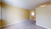 Located at 22027 S Vermont Ave in Torrance, CA, this single-floor, one-bedroom, one-bathroom unit offers a compact and efficiently designed living space. The layout flows from the main living area through a connecting hallway to the bedroom and supporting rooms.

The generously sized bedroom occupies the majority of the unit's footprint, featuring warm golden-yellow walls, white crown molding, and soft wall-to-wall carpeting that adds comfort underfoot. A sliding window allows natural light to filter in, accompanied by a private entry door. The room provides ample space for furnishings and personal use.

The kitchen is thoughtfully appointed with white cabinetry, granite-toned countertops, a double-basin sink, and a gas range with an overhead vent. Tile flooring and a window above the sink provide both practicality and natural light, making the space functional despite its compact footprint.

The bathroom features a tiled shower-tub combination enclosed by a sliding glass door, with a frosted window above for natural light and ventilation. The clean, neutral finishes throughout contribute to a bright and well-maintained feel.

Crown molding is consistent throughout the unit, lending a polished touch to the interiors. The warm color palette, combined with the functional layout and well-maintained finishes, makes this an efficient and comfortable single-level unit in the South Bay area of Los Angeles County.