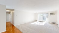 Located at 515 Lexington Pkwy S in Saint Paul, Minnesota, this single-floor residence offers four bedrooms, two bathrooms, and a well-designed layout that maximizes comfort and functionality. The living area is bright and open, featuring plush carpeting, a textured ceiling, and a sliding glass door that fills the space with natural light while providing access to an outdoor balcony area. Classic parquet wood flooring adds warmth to transitional spaces throughout the home. The kitchen is well-equipped with white cabinetry, dark granite-style countertops, and a full suite of stainless steel appliances including a range, microwave, dishwasher, and refrigerator, all set on durable tile flooring. The generously sized primary bedroom offers ample space and includes a large closet with louvered bifold doors and built-in shelving. The additional bedrooms are carpeted and each feature ceiling fans and good natural light. One bedroom includes a built-in desk with matching countertop, ideal for a home office setup. The two bathrooms are finished in classic white tile — one features a walk-in corner shower with a glass door, while the other offers a full tub-shower combination. The overall aesthetic is clean, neutral, and move-in ready.