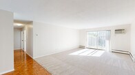 Located at 515 Lexington Pkwy S in Saint Paul, Minnesota, this single-floor residence offers four bedrooms, two bathrooms, and a well-designed layout that maximizes comfort and functionality. The living area is bright and open, featuring plush carpeting, a textured ceiling, and a sliding glass door that fills the space with natural light while providing access to an outdoor balcony area. Classic parquet wood flooring adds warmth to transitional spaces throughout the home. The kitchen is well-equipped with white cabinetry, dark granite-style countertops, and a full suite of stainless steel appliances including a range, microwave, dishwasher, and refrigerator, all set on durable tile flooring. The generously sized primary bedroom offers ample space and includes a large closet with louvered bifold doors and built-in shelving. The additional bedrooms are carpeted and each feature ceiling fans and good natural light. One bedroom includes a built-in desk with matching countertop, ideal for a home office setup. The two bathrooms are finished in classic white tile — one features a walk-in corner shower with a glass door, while the other offers a full tub-shower combination. The overall aesthetic is clean, neutral, and move-in ready.
