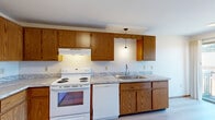 Located at 2721 Humboldt Rd in Green Bay, Wisconsin, this single-floor, 3-bedroom, 1-bathroom unit is housed within a classic red brick building that exudes timeless curb appeal. A private wood-railed balcony accessible from the unit provides an inviting outdoor retreat with pleasant neighborhood views.

Inside, the layout is practical and well-organized, connected by a central hallway. The living room features light hardwood-style flooring and bright white walls that reflect natural light, creating an open and airy feel. The kitchen is equipped with warm oak cabinetry, granite-patterned countertops, a double-basin stainless steel sink, and white appliances including a range, dishwasher, and full-size refrigerator. Pendant lighting adds a finishing touch to the functional workspace.

The three bedrooms offer comfortable retreats, with the spacious primary bedroom featuring hardwood-style flooring, while the secondary bedrooms are carpeted in neutral tones and include natural window light. Four closets throughout the unit provide ample storage. The full bathroom is clean and efficiently designed, featuring a tub-shower combination, a white vanity with a mirrored medicine cabinet, and matching hardwood-style flooring. Warm wood-toned door trim is consistent throughout, lending a cohesive character to the entire space.