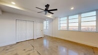 Located at 231 E 25th St in Little Rock, AR, this 2-bedroom, 1-bathroom unit offers a modern, industrial-inspired design across a single floor. Polished concrete floors run throughout the entire space, providing a sleek, low-maintenance foundation that reflects natural light and ties the rooms together cohesively.

The open-concept kitchen, dining, and living area serves as the heart of the home. The kitchen stands out with light wood cabinetry, a bold green ceramic tile backsplash, stainless steel appliances including a range with hood vent and a side-by-side refrigerator, and a large island with an undermount sink and pendant lighting above.

Both bedrooms are generously proportioned, each featuring ceiling fans, recessed lighting, and wide horizontal windows that allow abundant natural light and open views of the surrounding area. The spacious primary bedroom includes a built-in closet with bifold doors. A hallway with additional closet storage connects the bedrooms to the shared bathroom, which features a tiled tub-surround with floor-to-ceiling stone-look tile and matte black fixtures.

Additional spaces include a utility room, pantry, and dedicated laundry area, providing practical storage and functional convenience. Clean white walls throughout the unit complement the contemporary aesthetic.