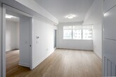 Located on the 16th floor at 33 Dunfield Avenue in Toronto's vibrant Midtown neighbourhood, this two-bedroom, one-bathroom unit offers a efficiently designed layout with a clean, modern aesthetic throughout. Light-toned hardwood flooring runs continuously through the main living areas, complementing the crisp white walls and recessed lighting that keep the space feeling bright and airy.

The kitchen is thoughtfully appointed with flat-front white cabinetry, a classic subway tile backsplash, and a full suite of stainless steel appliances including a refrigerator, stove, built-in microwave, and dishwasher. The open sightline from the kitchen into the living area enhances the sense of space.

The primary bedroom is a well-proportioned retreat featuring floor-to-ceiling windows and direct access to a private balcony, filling the room with natural light and offering views of the surrounding cityscape. Sliding mirrored closet doors add both storage and a sense of depth to the room. The second bedroom, accessible via a hallway with recessed lighting, is equally bright with a clean, neutral finish.

The bathroom is finished in crisp white tile with a floating vanity, a full-width mirror, and a combined tub and shower, maintaining the consistent modern palette found throughout the unit. The overall ambiance is sleek, minimal, and move-in ready.