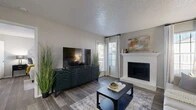 Located at 8925 Randol Mill Rd in Fort Worth, TX, this single-floor, one-bedroom, one-bathroom residence offers a thoughtfully designed layout that maximizes every square foot. The combined kitchen and living area serves as the heart of the home, where wood-style flooring, neutral gray walls, and a textured ceiling create a warm, cohesive atmosphere. The living room is anchored by a white brick fireplace with a classic mantle, complemented by large windows that invite natural light. The kitchen features white cabinetry, granite-style countertops, a mosaic tile backsplash, stainless steel appliances including a refrigerator and microwave, and a breakfast bar that provides additional prep and dining space. A dedicated pantry adds practical storage. The bedroom is a comfortable retreat with multiple windows, hardwood-style flooring, and access to two closets — one of which is a spacious walk-in with built-in shelving. The full bathroom includes a tub-shower combination and granite-style vanity. A dedicated laundry area adds everyday convenience, rounding out a functional and well-organized living space.