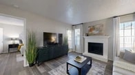 Located at 8925 Randol Mill Rd in Fort Worth, TX, this single-floor, one-bedroom, one-bathroom residence offers a thoughtfully designed layout that maximizes every square foot. The combined kitchen and living area serves as the heart of the home, where wood-style flooring, neutral gray walls, and a textured ceiling create a warm, cohesive atmosphere. The living room is anchored by a white brick fireplace with a classic mantle, complemented by large windows that invite natural light. The kitchen features white cabinetry, granite-style countertops, a mosaic tile backsplash, stainless steel appliances including a refrigerator and microwave, and a breakfast bar that provides additional prep and dining space. A dedicated pantry adds practical storage. The bedroom is a comfortable retreat with multiple windows, hardwood-style flooring, and access to two closets — one of which is a spacious walk-in with built-in shelving. The full bathroom includes a tub-shower combination and granite-style vanity. A dedicated laundry area adds everyday convenience, rounding out a functional and well-organized living space.