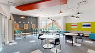 Located at 111 Cooper St in Ottawa's Centretown neighbourhood, this single-floor commercial space offers a generously sized, open-concept layout designed to support flexible, collaborative use. The interior is defined by a bold, contemporary aesthetic that balances energetic colour accents with functional design.

The space is organized into distinct seating zones that accommodate a variety of activities. A casual lounge area features a neutral sofa, a teal accent armchair, and low yellow coffee tables set against a striking yellow and white geometric wall treatment. Adjacent to this, round white pedestal tables paired with sleek black chairs provide versatile settings for meetings or individual work. A separate high-top zone along a charcoal feature wall offers bar-height wooden tables with teal stools beneath pendant lighting, creating a more informal, social atmosphere.

A bold red ceiling soffit element runs through the central area, anchoring the open layout and adding architectural interest above. Industrial-style and minimalist pendant lights illuminate the space throughout. Large windows along one wall draw in natural light and offer outdoor views, enhancing the bright and open ambiance. Patterned grey carpet tiles define the floor throughout. A copy/resource area and additional rooms are accessible from the main floor.