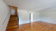 Located at 2101 Gorman St in Raleigh, NC, this two-story home offers three bedrooms, three full bathrooms, and a practical, well-organized layout spread across two floors. The main level provides the larger share of the living space and includes a living room, dining room, and kitchen. The living room features warm hardwood floors, crisp white walls, a textured ceiling, and a wood staircase with black metal railings that leads to the upper level. The kitchen is equipped with white cabinetry, dark countertops, a gas range, a double-basin sink, and a dishwasher, with tile flooring throughout. The upper level houses the bedrooms, each featuring hardwood floors and clean white walls. The primary bedroom offers a generous footprint with ample closet space. Bedrooms on the upper level receive natural light through windows with views of surrounding greenery. The three full bathrooms each include a tub/shower combination, white vanity cabinetry, and tile flooring. A dedicated laundry room with side-by-side washer and dryer adds everyday convenience. With five closets distributed throughout, storage is plentiful. The home's clean, neutral palette and classic hardwood floors create a bright, functional living environment.