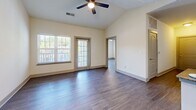 Located at 7201 Charlotte Pike in Nashville, TN, this well-appointed 3-bedroom, 2-bathroom single-story home offers a thoughtfully designed layout with modern finishes throughout. The open living room impresses with soaring vaulted ceilings, a ceiling fan, and large windows that invite generous natural light, creating a bright and airy atmosphere. Rich hardwood-style flooring flows seamlessly throughout the main living areas and bedrooms.

The kitchen is a standout feature, boasting crisp white cabinetry, granite countertops, a central island with additional granite surface space, stainless steel appliances including a refrigerator, range, microwave, and dishwasher, plus a tile backsplash and track lighting overhead.

Each of the three bedrooms offers comfortable proportions, with the primary bedroom providing a well-sized retreat. Bedrooms are equipped with ceiling fans, hardwood-style flooring, and bifold-door closets with built-in shelving. The two bathrooms are finished with tile flooring, granite vanity counters, and full tub-shower combinations with brushed nickel fixtures.

A dedicated in-unit laundry room features side-by-side washer and dryer units with overhead shelving and durable hardwood-style flooring, adding everyday convenience to this move-in-ready Nashville home.
