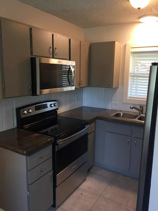 Kitchen with concrete countertops and new appliances - 1119 10th St.