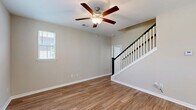 Located at 1501 Flatwood St in Murrells Inlet, SC, this well-appointed two-story home offers three bedrooms, three bathrooms, and a thoughtfully designed layout spread across two floors. The main level features an open-concept living room and kitchen, anchored by warm hardwood-style flooring and a ceiling fan with light kit. A classic staircase with white balusters and a dark newel post connects both levels. The kitchen is a standout, showcasing granite countertops, a central island with pendant lighting, crisp white shaker cabinetry, a stainless steel sink, and a full suite of stainless steel appliances including a refrigerator with ice maker, electric range, microwave, and dishwasher. Natural light flows in through multiple windows dressed with plantation-style blinds. Upstairs, the spacious primary bedroom features a tray ceiling, ceiling fan, plush carpeting, and access to a walk-in closet with wire shelving. The primary bathroom offers a dual-sink vanity with granite countertops and wood-style flooring. Two additional bedrooms, each with carpet and ceiling fans, share access to well-appointed bathrooms with tub/shower combinations. Each bedroom includes a dedicated closet. The home's neutral color palette and clean finishes create a bright, move-in-ready atmosphere throughout.