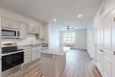 Located at 16631 E Colfax Ave in Aurora, CO, this well-appointed one-bedroom, one-bathroom unit offers a thoughtfully designed single-floor layout with a clean, modern aesthetic throughout. The open-concept kitchen and living area serves as the heart of the home, featuring a central granite-topped island that provides additional prep space and a natural gathering point. The kitchen is outfitted with gray shaker-style cabinetry, granite countertops, and a full suite of stainless steel appliances, including a refrigerator, electric range, microwave, and dishwasher. Wood-style plank flooring runs throughout the main living areas, complemented by recessed lighting and a ceiling fan that enhance both function and ambiance. The living area is bright and open, with a window that draws in natural light. The generously sized bedroom features plush carpeting, a wide window with outdoor views, a ceiling fan, and a closet. The bathroom is finished with gray cabinetry, a white countertop vanity, a large mirror, and wood-style flooring, maintaining the consistent modern palette found throughout the unit. Neutral wall tones and clean finishes give the entire space a fresh, move-in-ready feel.