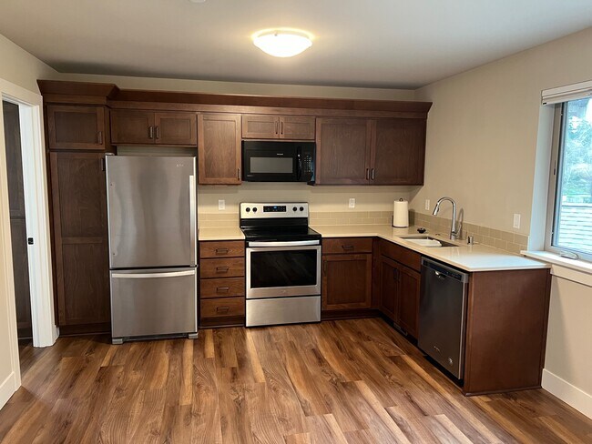 Kitchen with stainless steel appliances and quartz counters - 6121 NE 195th Pl