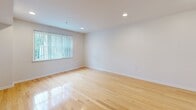 Located at 5801 Rittenhouse Street in Philadelphia's Germantown neighborhood, this single-floor, 2-bedroom, 2-bathroom unit offers a well-designed layout with a clean, modern aesthetic throughout. Warm hardwood flooring flows continuously across the living areas and bedrooms, lending the space a cohesive and inviting feel. The living room benefits from multiple windows that draw in natural light and provide views of the surrounding greenery, creating a bright and airy atmosphere. A decorative front entry door adds character to the entrance. The kitchen is a standout feature, showcasing dark espresso-toned cabinetry paired with crisp white countertops, a subway tile backsplash, and a full suite of stainless steel appliances including a gas range, microwave, dishwasher, and refrigerator. A central island provides additional prep space and enhances the kitchen's functionality. The spacious primary bedroom offers a comfortable footprint, while the second bedroom also provides ample room. Both bathrooms are finished with large-format tile flooring; one includes a glass-enclosed shower, while the other features a window for natural light and a dark-toned vanity. Recessed lighting throughout adds a polished, contemporary touch to this well-appointed Philadelphia residence.