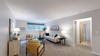 Located at 510 College Ave NE in Grand Rapids, Michigan, this one-bedroom, one-bathroom residence offers a practical and comfortable single-floor layout. The living room is generously proportioned, featuring soft carpet flooring, neutral gray walls, and a wide window that allows natural light to fill the space. A wall-mounted air conditioning unit provides climate control, and the open arrangement comfortably accommodates a full seating area.

The kitchen stands out with its modern design, showcasing flat-front cabinetry in a warm taupe finish, a subtle tile backsplash, light wood-look flooring, and a full suite of stainless steel appliances including a refrigerator, range, microwave, and dishwasher. Ample upper and lower cabinet storage adds to its functionality.

The bedroom offers a calm retreat with carpeted floors, light-toned walls, and a window with a roller shade. A built-in closet with wooden sliding doors provides convenient storage. The full bathroom includes tile flooring, a shower/tub combo, toilet, and vanity. Two hallways connect the rooms, contributing to a logical and efficient flow throughout the unit. This residence offers a clean, move-in-ready living experience in a central Grand Rapids location.