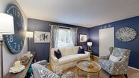 Located at 3 Sawgrass Rd in Charleston, SC, this single-floor, 2-bedroom, 2-bathroom home showcases a cohesive coastal aesthetic throughout. The living room makes a strong first impression with bold navy blue accent walls, carpet flooring, and a textured ceiling, creating a warm and inviting atmosphere that carries through the entire home. A dedicated dining area features chair-rail molding and an arched mirror detail, adding architectural character to the space.

The galley-style kitchen is well-appointed with dark cabinetry, granite countertops, a tile backsplash, stainless steel appliances, and hardwood-style flooring — all opening directly to the in-unit laundry room, which includes a full-size washer and dryer, a water heater, and built-in shelving for added storage.

Both bedrooms continue the nautical blue-and-white theme, with the primary bedroom featuring a ceiling fan and a blue accent wall. Each bedroom benefits from its own closet, with one offering a spacious walk-in design with built-in shelving and hanging rods. The bathrooms are clean and functional, with one including a full tub-shower combination. Two additional closets provide ample storage throughout the home.