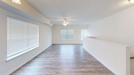 Located at 2411 Tinas Way in Seaford, Delaware, this well-appointed one-bedroom, two-bathroom residence offers a thoughtfully designed single-floor layout that maximizes comfort and functionality. The open-concept living and dining area is bright and airy, featuring wood-style flooring, crisp white walls, and multiple windows dressed with blinds that invite generous natural light. A ceiling fan with integrated lighting adds both style and practicality to the space.

The kitchen is a standout feature, showcasing rich dark-espresso shaker cabinetry, light countertops, a stainless steel refrigerator, range, and over-the-range microwave, all set atop durable wood-style flooring — a combination that balances elegance with everyday function.

The spacious primary bedroom is finished with plush carpeting, a ceiling fan, and multiple windows that provide ample natural light and ventilation. A closet offers convenient built-in storage. The two bathrooms are clean and functional: one features a tub/shower combo and wood-style flooring, while the second offers a vanity with dark cabinetry and a bright window. Throughout, neutral tones and consistent finishes create a cohesive, move-in-ready ambiance.