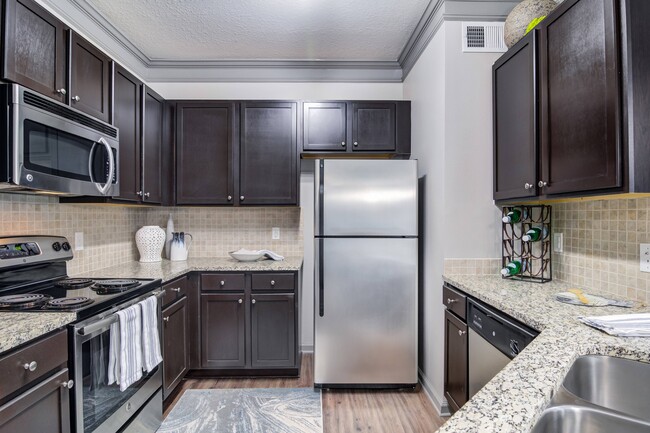 Kitchen with Stainless Steel Appliances - Waterstone at Big Creek Apartments