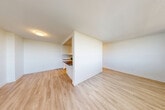 Located at 25 Fisherville Road in North York, Toronto, this well-appointed two-bedroom, one-bathroom unit offers a bright and functional layout across a single floor. Light-toned laminate flooring runs throughout the space, lending a clean and cohesive feel to every room. The open living area is bathed in natural light through large windows, with a balcony access point that opens to panoramic views of lush tree canopies and the Toronto skyline beyond — an exceptional outdoor feature for urban living. The kitchen has been tastefully renovated with crisp white cabinetry, dark stone countertops, a classic subway tile backsplash, stainless steel appliances, and recessed lighting, creating a polished and practical cooking space. Both bedrooms are generously proportioned with large windows that frame green outdoor views, and the primary bedroom includes mirrored sliding closet doors that enhance the sense of space. The bathroom features full subway tile surround, a soaker tub with overhead shower, and chrome fixtures, maintaining the unit's clean, modern aesthetic throughout. Baseboard heating is present in key rooms, and crisp white walls throughout contribute to a fresh, move-in-ready ambiance.