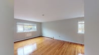 Located at 35 Penataquit Avenue in Bay Shore, NY, this apartment at Mid Island Apartments is a single-floor residence that combines functional design with clean, updated finishes. Throughout the unit, gleaming hardwood floors in warm honey tones create a cohesive and inviting atmosphere, complemented by soft gray walls and crisp white trim.

The living areas are bright and open, benefiting from multiple windows dressed with white blinds that allow natural light to fill each room. Baseboard heating runs along the walls in all primary rooms, ensuring year-round comfort, and select rooms also feature wall-mounted air conditioning units.

The kitchen stands out with white shaker-style cabinetry, marble-look countertops, a gray subway tile backsplash, and stainless steel appliances including a gas range and over-the-range microwave — offering both style and practicality.

The bedrooms are generously sized, each with polished hardwood floors and windows overlooking the surrounding neighborhood. One bedroom includes access to a dedicated closet space. The bathroom features full white tile surrounding a soaking tub and shower combination, paired with a marble-top vanity for a clean, classic finish.

Overall, this unit presents a well-maintained, move-in ready space with consistent finishes and ample natural light throughout.