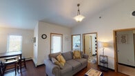 Located at 1515 11th Ave N in Fargo, North Dakota, this single-floor residence offers a thoughtfully designed layout with a comfortable, functional flow throughout. The living area serves as the heart of the home, boasting notably high vaulted ceilings that create a sense of openness and volume. Rich hardwood-style flooring, a stylish pendant light fixture, and a large window that invites natural light give the space a warm and welcoming ambiance. A dining area with direct access to an exterior door sits adjacent to the living room, enhancing both convenience and connectivity.

The galley-style kitchen is well-equipped with warm wood cabinetry, granite countertops, stainless steel appliances including a refrigerator, electric range, and microwave, as well as light hardwood flooring that ties the space together seamlessly.

Two carpeted bedrooms each feature ceiling fans with light fixtures, ample natural light, and closet storage. One bedroom includes a window with outdoor views of surrounding greenery, adding a refreshing touch.

Two full bathrooms offer rich wood vanities, tile flooring, and generous counter and storage space. One bathroom includes a tub-shower combination. The unit also features in-unit laundry, adding everyday practicality to this comfortable Fargo residence.