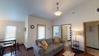 Located at 1515 11th Ave N in Fargo, North Dakota, this single-floor residence offers a thoughtfully designed layout with a comfortable, functional flow throughout. The living area serves as the heart of the home, boasting notably high vaulted ceilings that create a sense of openness and volume. Rich hardwood-style flooring, a stylish pendant light fixture, and a large window that invites natural light give the space a warm and welcoming ambiance. A dining area with direct access to an exterior door sits adjacent to the living room, enhancing both convenience and connectivity.

The galley-style kitchen is well-equipped with warm wood cabinetry, granite countertops, stainless steel appliances including a refrigerator, electric range, and microwave, as well as light hardwood flooring that ties the space together seamlessly.

Two carpeted bedrooms each feature ceiling fans with light fixtures, ample natural light, and closet storage. One bedroom includes a window with outdoor views of surrounding greenery, adding a refreshing touch.

Two full bathrooms offer rich wood vanities, tile flooring, and generous counter and storage space. One bathroom includes a tub-shower combination. The unit also features in-unit laundry, adding everyday practicality to this comfortable Fargo residence.